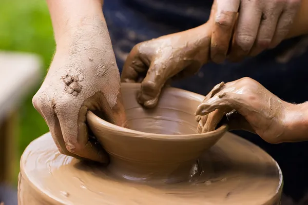 Potters and child hands — Stock Photo, Image