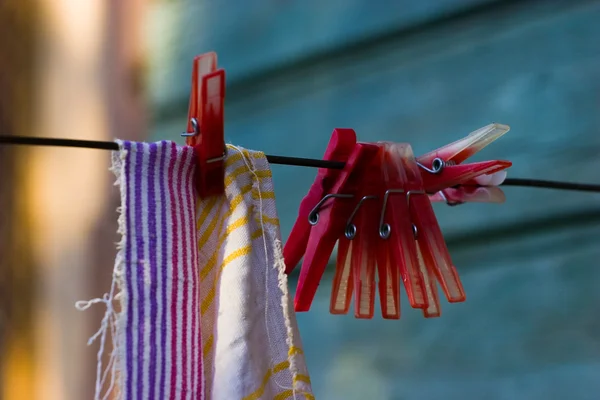 Kırmızı plastik clothespins ve havlu — Stok fotoğraf