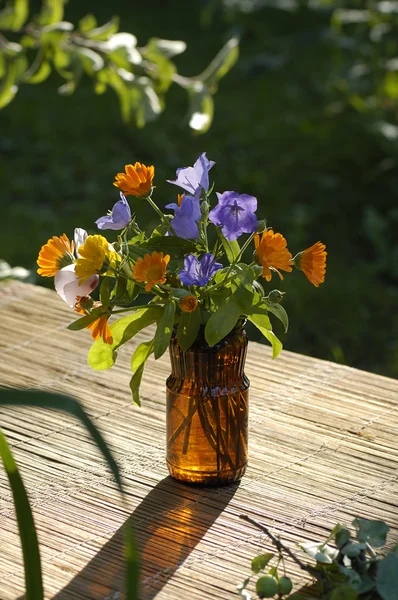 Small bouquet in brown glass — Stock Photo, Image