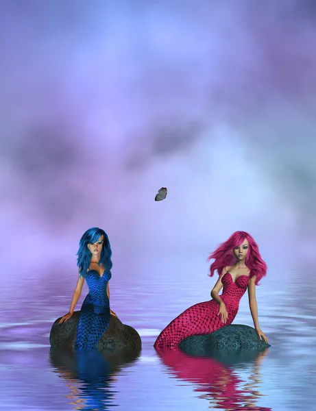 Dvě mořské panny, sedí na skále — Stock fotografie
