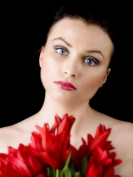 Stock image Woman with red tulips