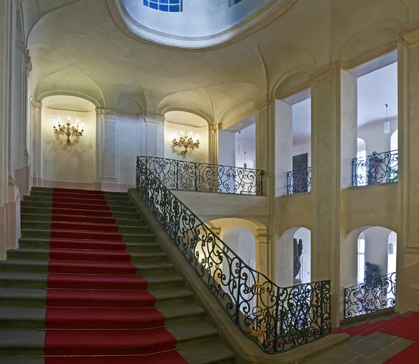 Ancient staircase with red carpet — Stock Photo, Image