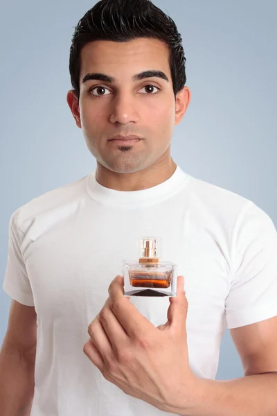 En man håller en flaska cologne — Stockfoto