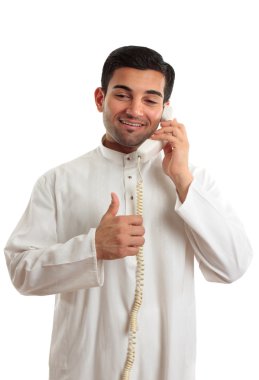 Happy ethnic businessman on phone clipart