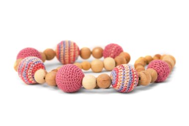 Crocheted and wooden pink beads isolated clipart