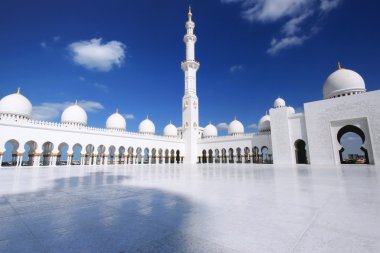 White mosque with cloudy blue sky clipart