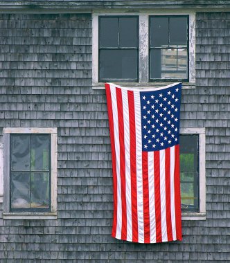 U.S. Flag hanging on building clipart