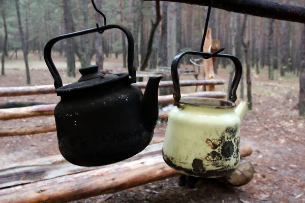 Two kettles in forest camp — Stock Photo, Image