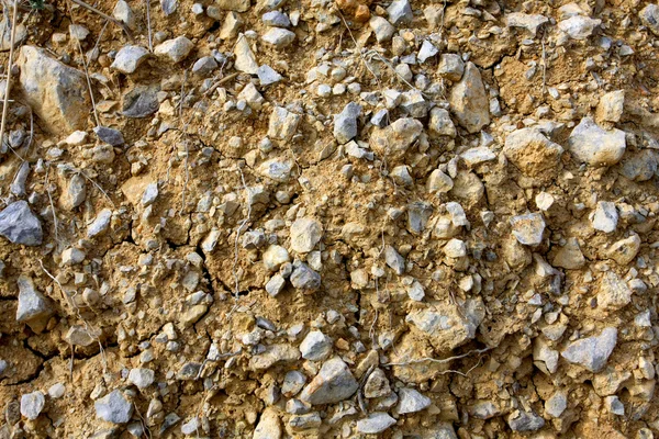 Background with stones on yellow clay — Stock Photo, Image