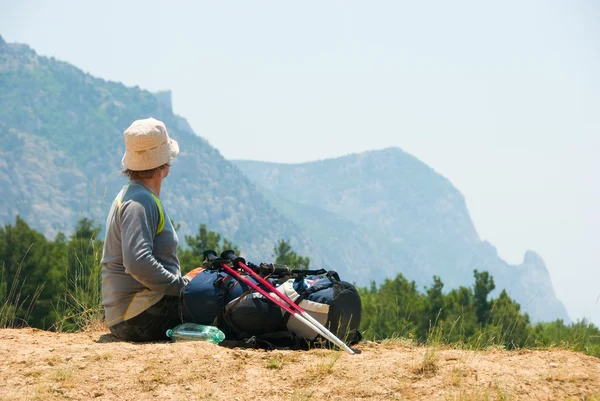Уставший турист расслабляется на холме — стоковое фото
