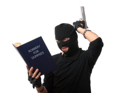 Perplexed robber reads book over white. clipart