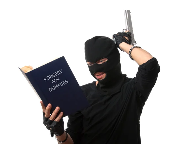 Perplexed robber reads book over white. — Stock Photo, Image