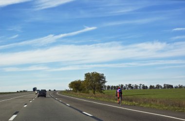 Bicyclist on the highway clipart