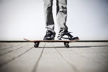 Skater standing on his skateboard clipart