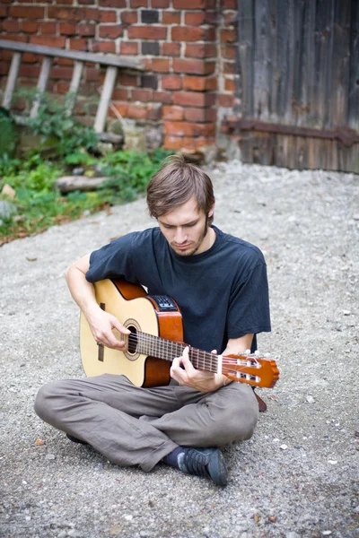 Грубий сільський хлопець грає на гітарі — стокове фото