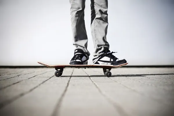 Skater standing on his skateboard Stockfoto