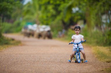 Cute girl riding her bike clipart