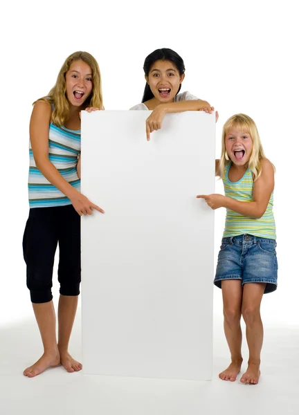 Tři mladé ženy s bílou tabuli — Stock fotografie