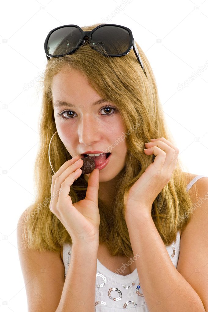 Girl eating a chocolate truffle