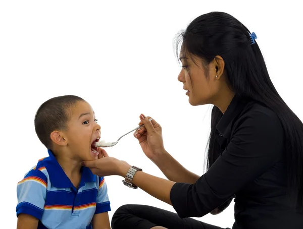 Mother feeding her son — Stock Photo, Image