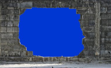 Hole in a wall isolated on blue clipart