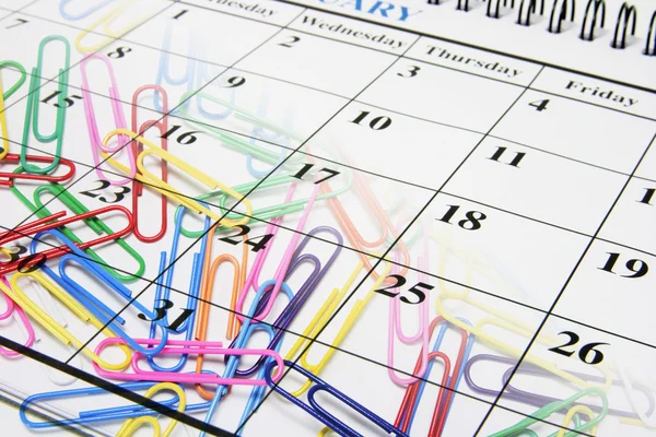 Büroklammern und Kalender — Stockfoto