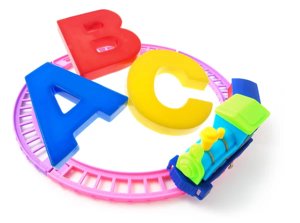 Trem de brinquedo e alfabetos — Fotografia de Stock