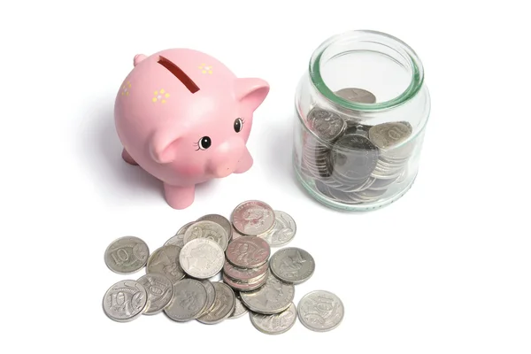 Piggybank e moedas em frasco de vidro — Fotografia de Stock
