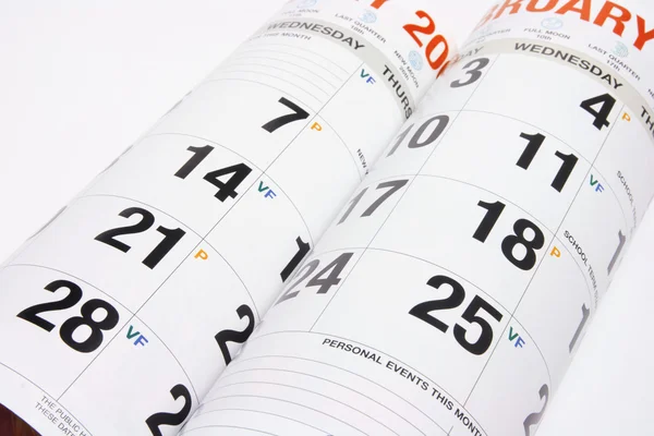 Часы и страницы календаря — стоковое фото