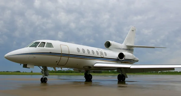 Private business jet on rainy ramp — Stockfoto