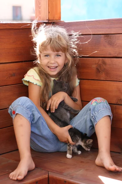 stock image Young girl playing with cats