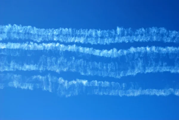 Smoke traces in blue sky — Stock Photo, Image