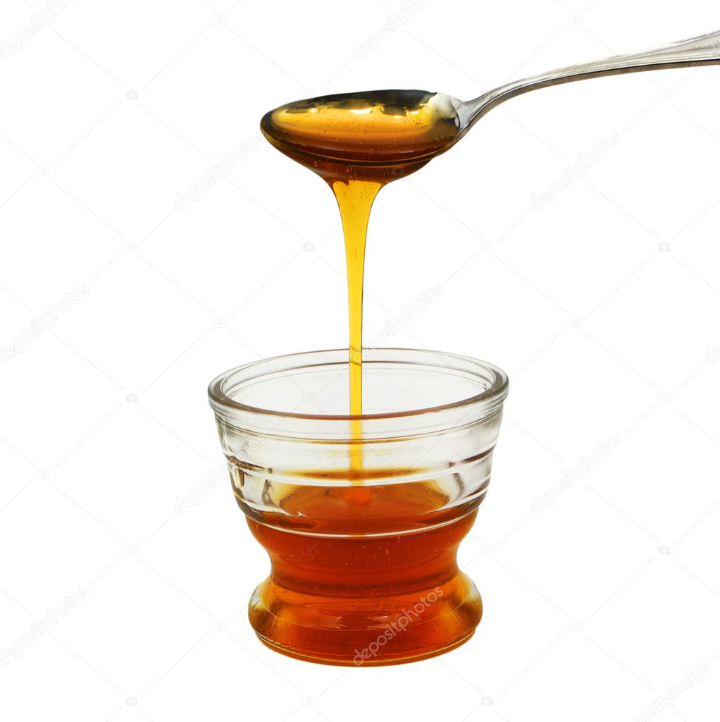 Honey pouring into small glass bowl