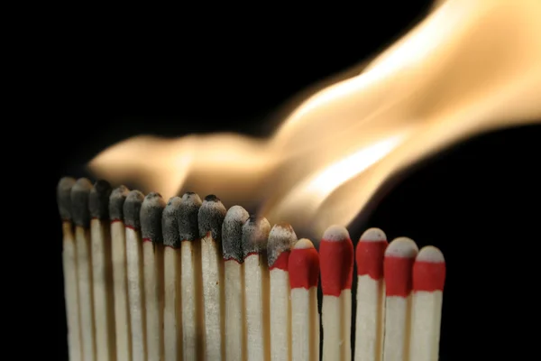 A row of igniting matches — Stock Photo, Image