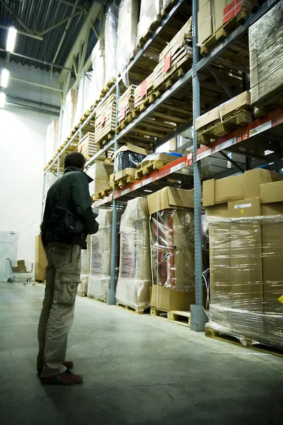 Men in big warehouse — Stock Photo, Image