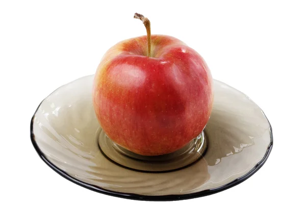 Apfel auf einem Teller (seitlich) — Stockfoto