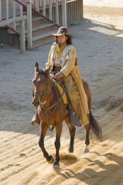 Cowboy riding into town clipart