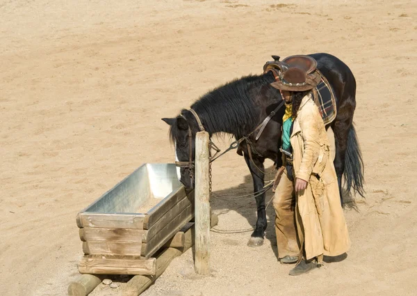 Cowboy watering his horse — Stock Photo, Image