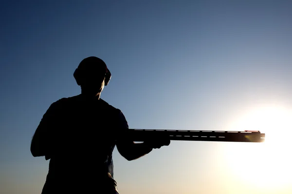 Shooting with a gun silhouette — Stock Photo, Image