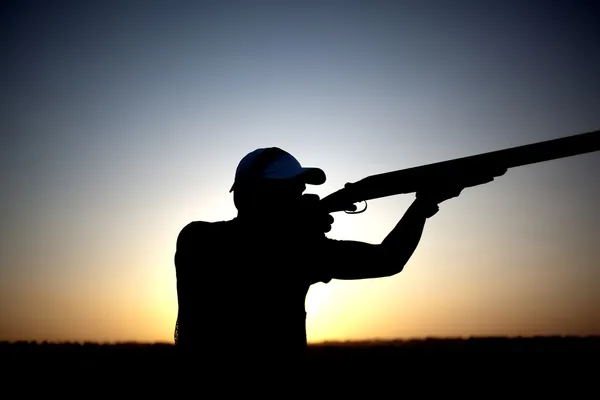 Střelba s pistolí silueta — Stock fotografie
