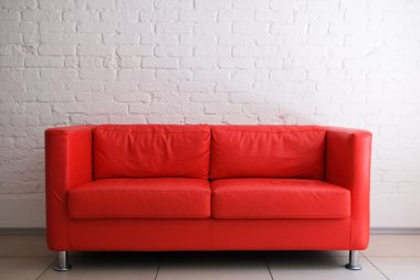 Red sofa and white brick wall clipart