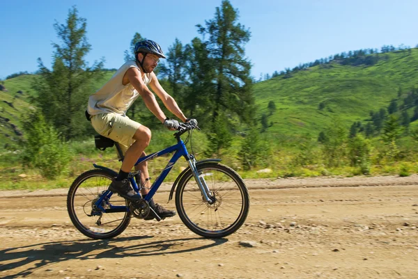Biker on rural mountain road — Stock Photo, Image