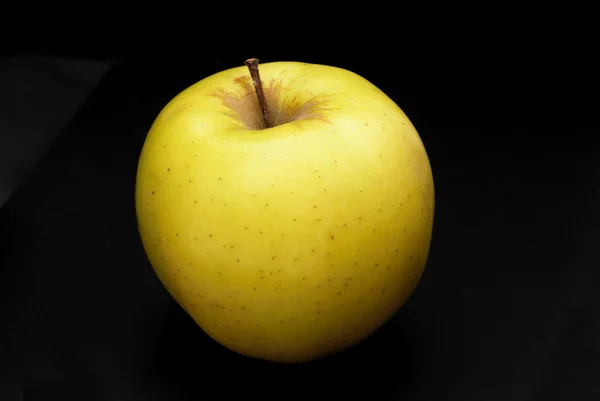 Yellow apple on black — Stock Photo, Image
