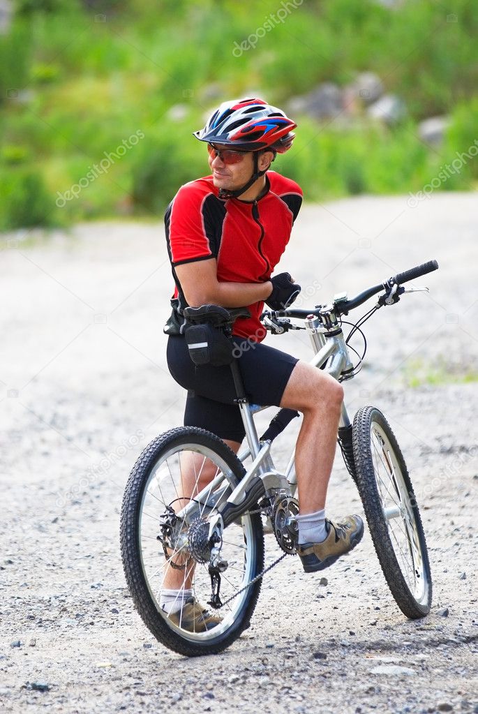 Mountain biker waits on rural road