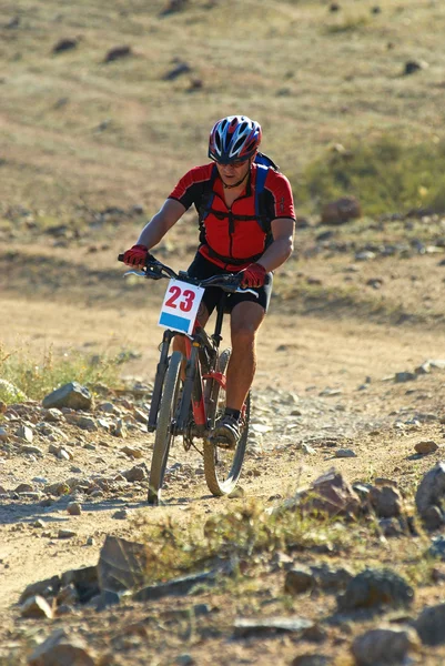 Mountainbike-åkaren racing i öknen — Stockfoto