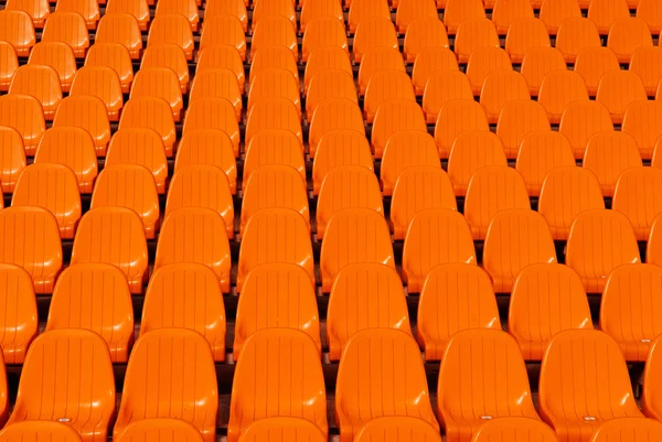 Laranja assentos estádio fundo — Fotografia de Stock
