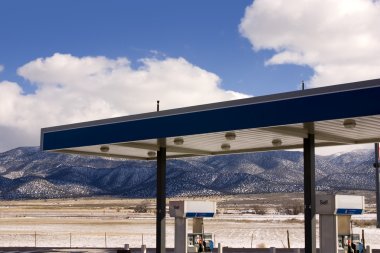 Gas Station and Cloudy Skies clipart