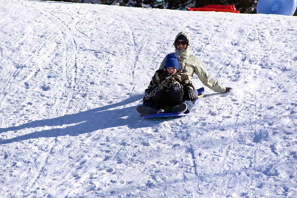 Mother and Son Sledding down the Hill