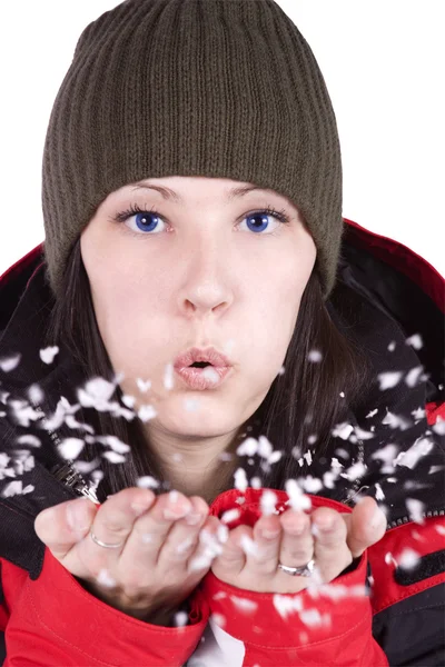 Woman blowing soft white flakes — Stock Photo, Image
