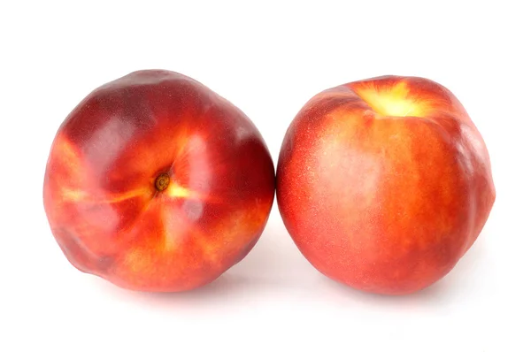 stock image Two red nectarine peaches isolated on white back